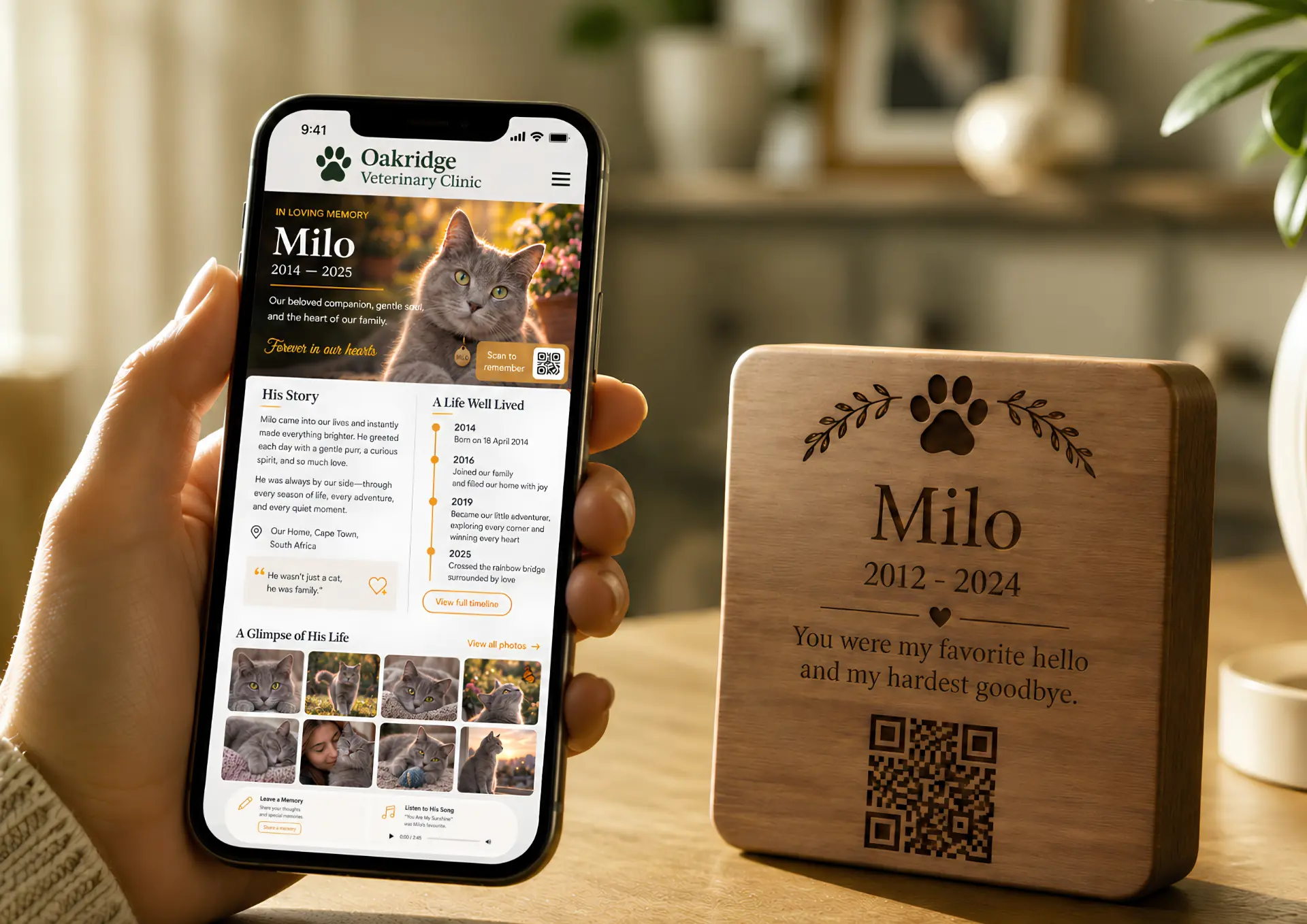 A hand holding a smartphone showing a digital pet memorial page beside a keepsake with a QR code